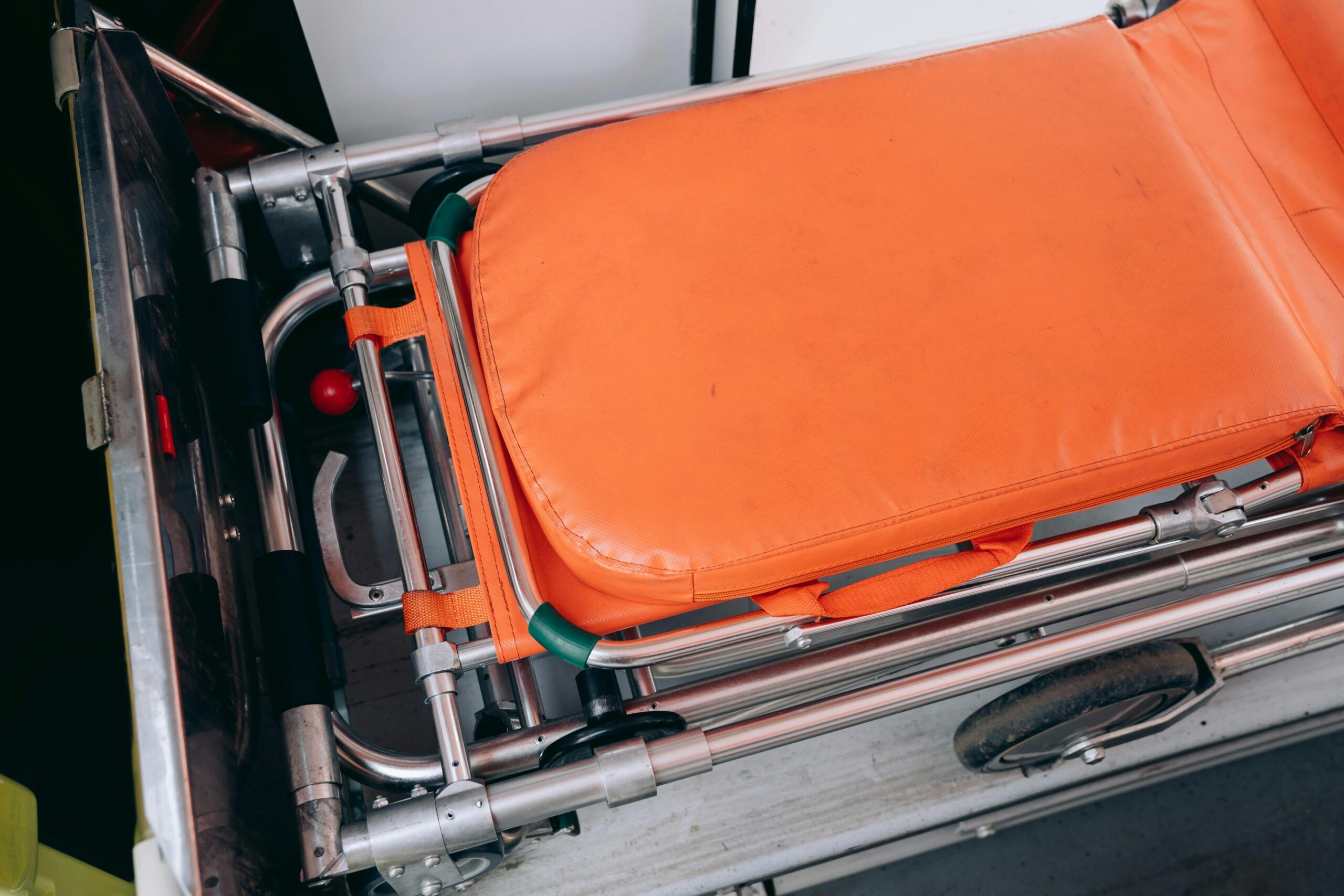 Home Close-up view of an orange stretcher inside an ambulance, emphasizing medical equipment.